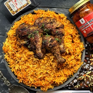 Pilau spiced chicken and west African jollof rice made with the sauce African tomato sauce